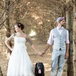 Bride and groom posing with dog