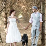 Bride and groom posing with dog