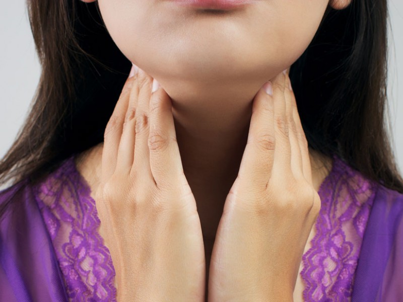 woman checking thyroid